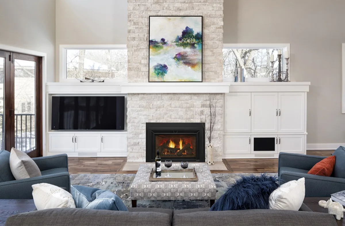 Heat & Glo Supreme gas insert with an Iron Age finish installed in a living room